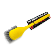 Yellow car scrub brush with gray bristles on a white background