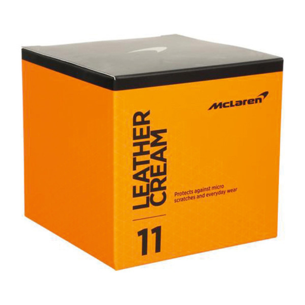 Orange box of McLaren leather cream with black lid on a white background