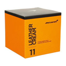 Orange box of McLaren leather cream with black lid on a white background